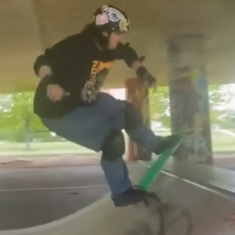 Mike Scrase, a blind skateboarder, doing a rock to fakie on a mini ramp.
