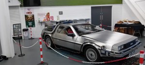 A photo of a full size replica of Back to the Future's DeLorean on the convention floor of Bristol Comic Con.