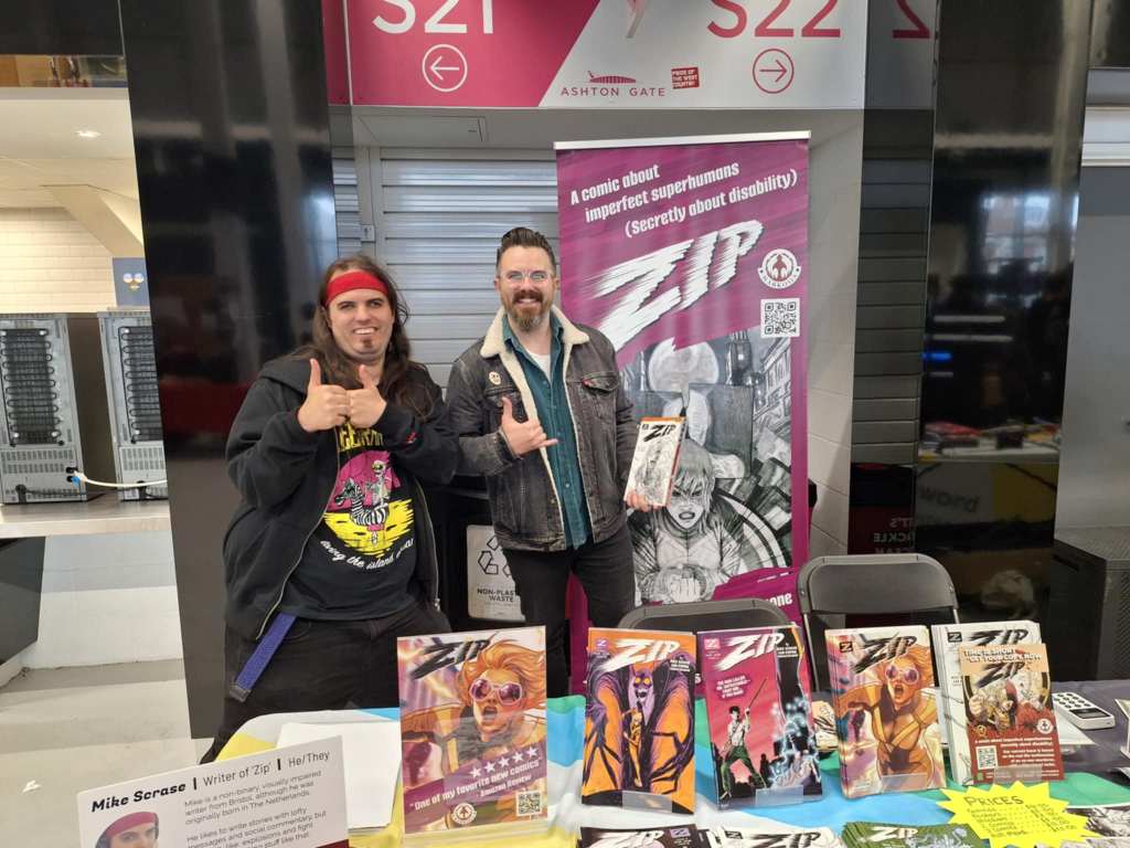 Photo of writer Mike Scrase doing the 'thwip fingers' Spider-Man makes when he shoots a web, with a Spider-Man cosplayer.